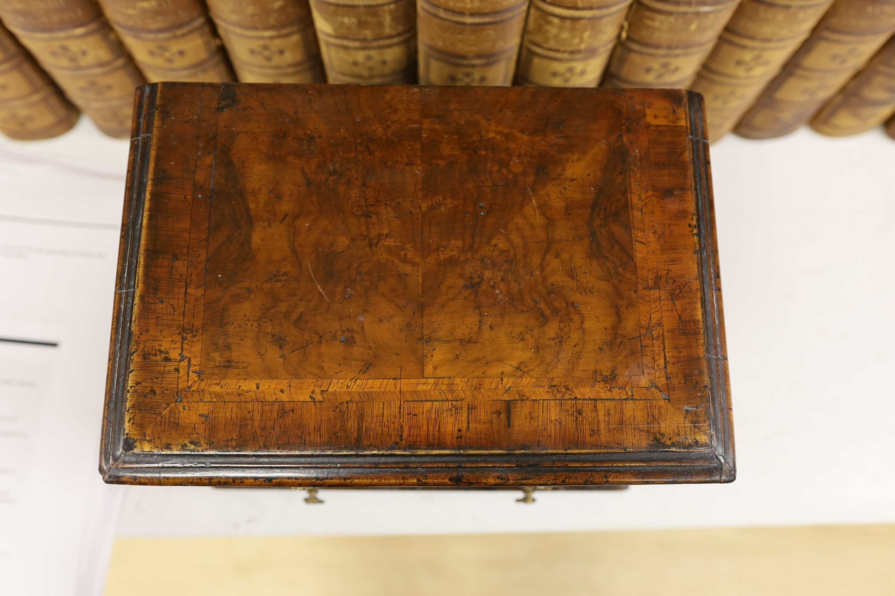 A cross banded walnut miniature chest of three drawers, 26cm wide